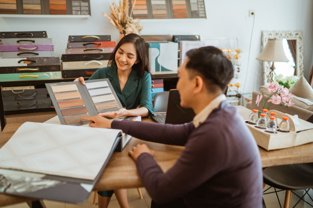 DSB Home Interiors - the asian customer pointing on the material palette that showed by the female shopkeeper